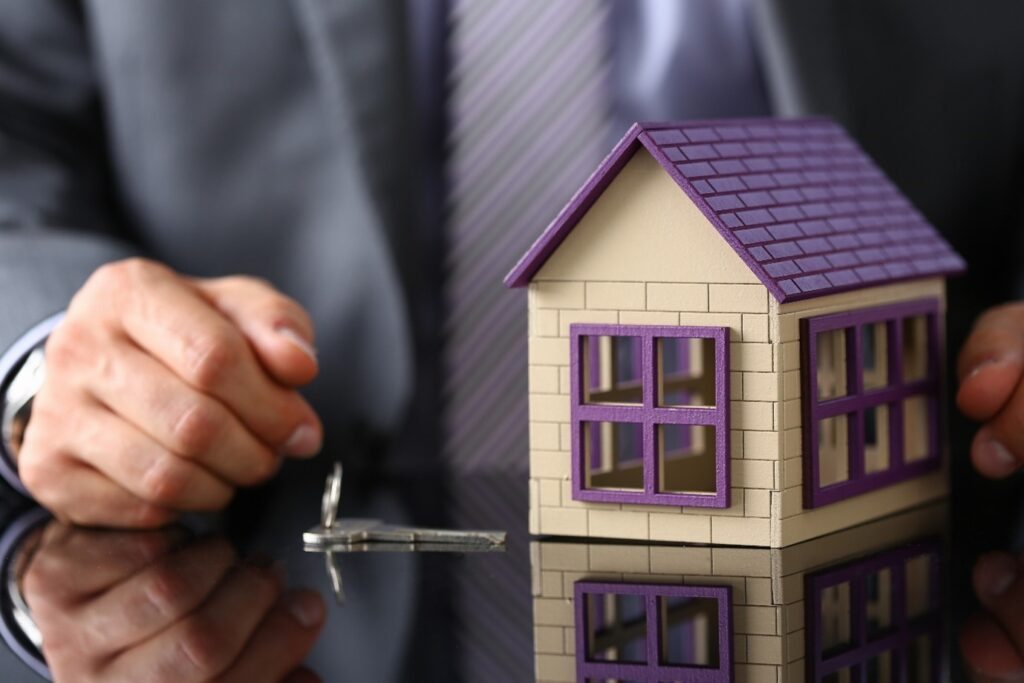image of businessman with building and key