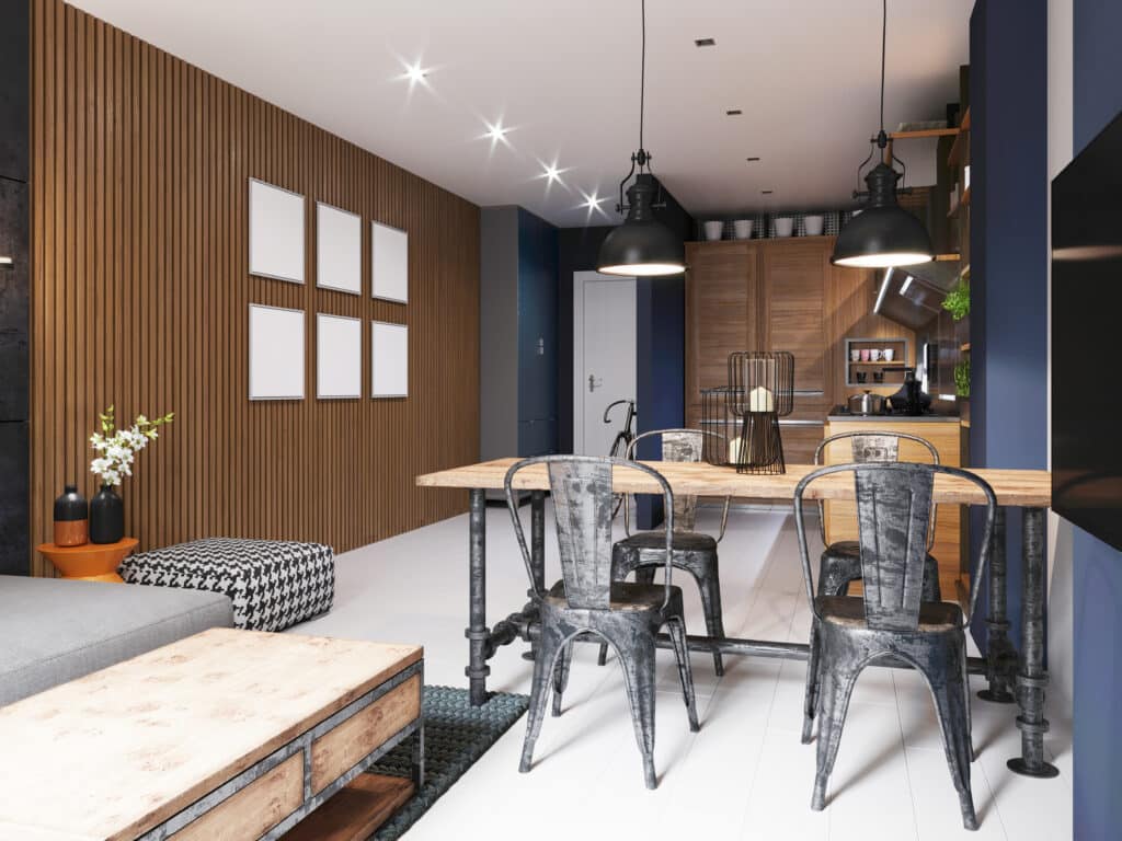 Shared living area. Dining area in the kitchen with deep blue walls with an iron table and chairs, in an industrial loft style. 3d rendering.