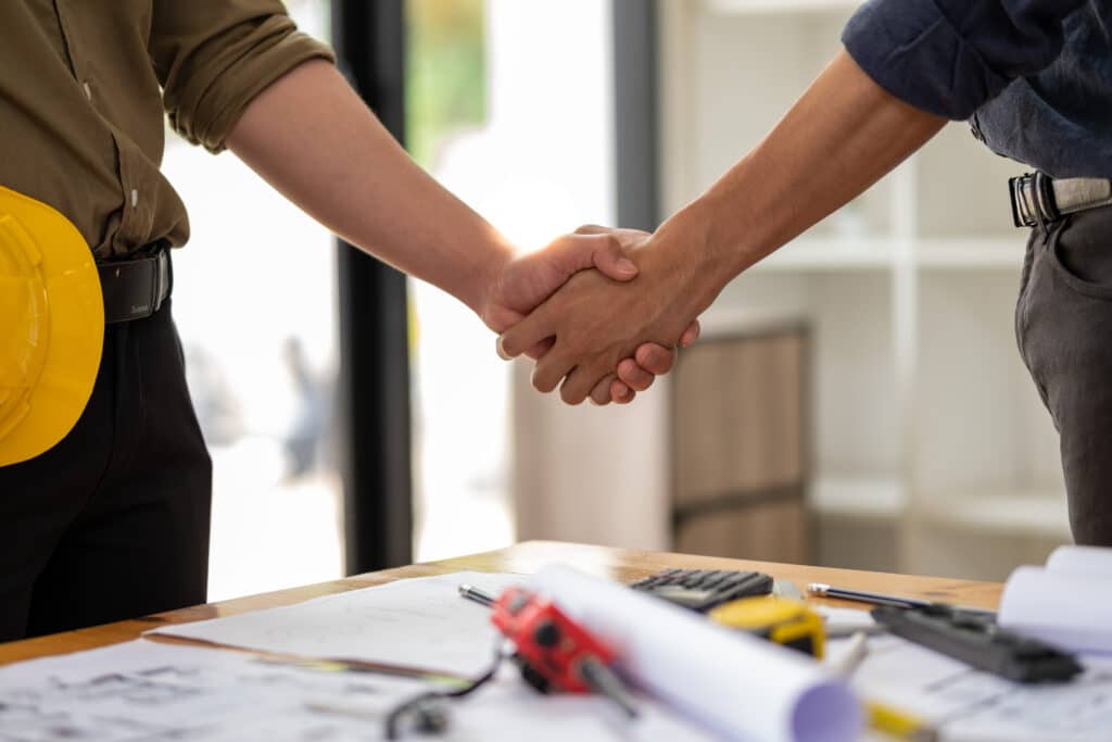 Architect engineer shaking hand, engineer architect congratulation finish deal meeting conference