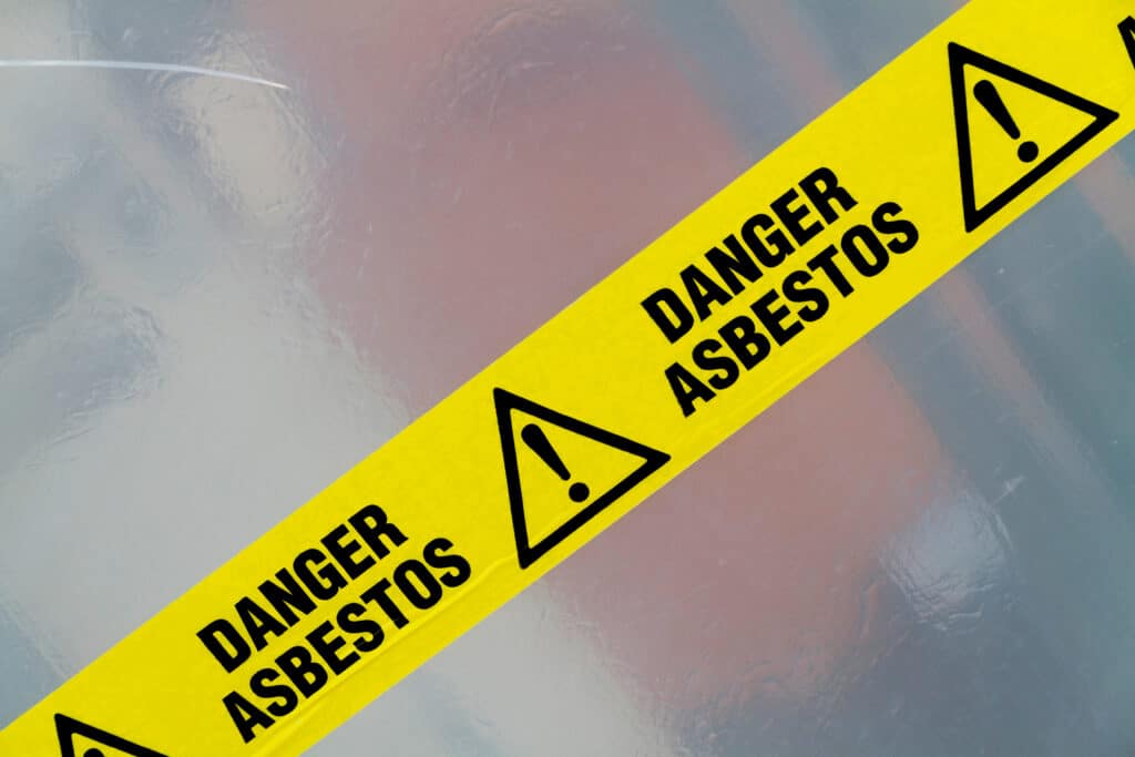 Danger Asbestos yellow warning tape close up