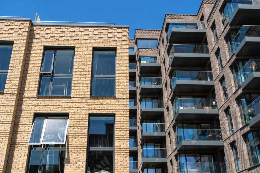 Striking the Right Balance: How Accurate Valuations Protect Both Landlords and Leaseholders Modern Residential Buildings With Brick And Glass Facades Under Clear Blue Sky